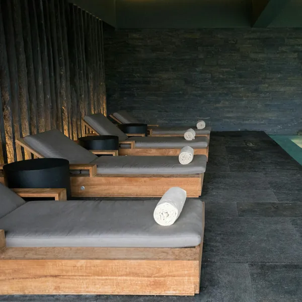 Loungers with rolled towels in a quiet spa lounge